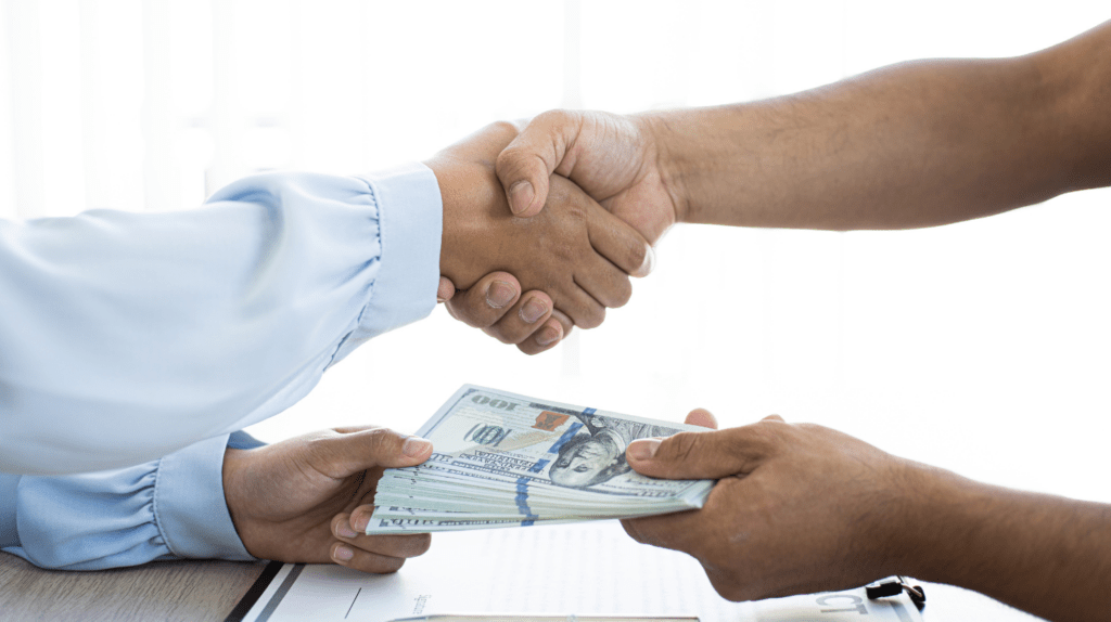 shaking hands in agreement, monetary agreement